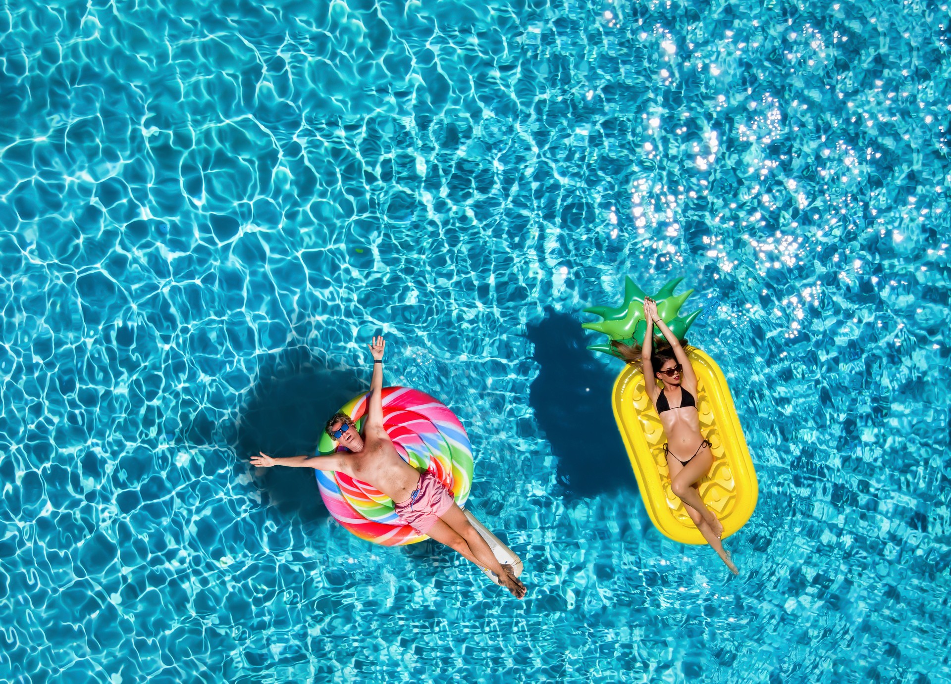 Directly Above Shot Of Friends On Inflatables